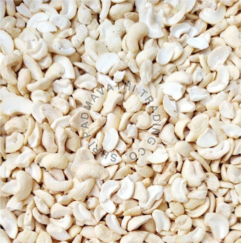 Creamy 4 Pieces Cashew Nuts, for Sweets, Direct Consumption, Packaging Type : Plastic Pack