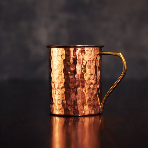 COPPER MUG WITH BRASS HANDLE HAMMERED DESIGN.