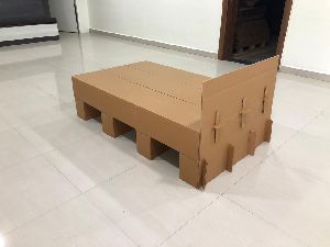 cardboard covid bed and side stool.
