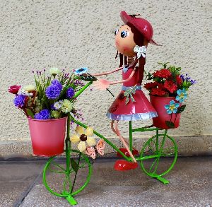Pretty pink girl riding cycle planter